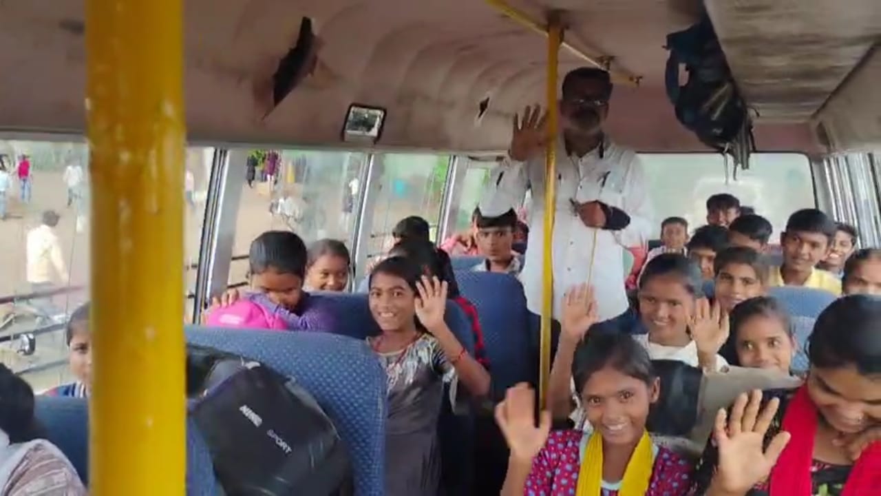 Smiling schoolchild boarding a yellow bus in rural Chhatrapati sambhaji nagar