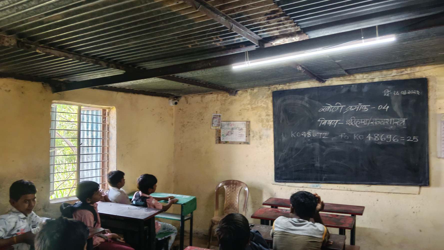 Students in an old classroom needing restoration